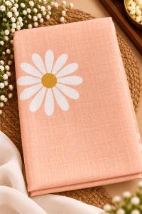 Folded saree featuring a large floral motif and a subtle textured fabric finish, styled in a professional product photography setting.