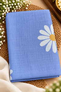 Folded saree featuring a large floral motif and a subtle textured fabric finish, styled in a professional product photography setting.